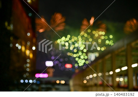 Bokeh effect of colorful fireworks display in the night sky. Real fireworks background. Abstract of real shining fireworks against black background. Glowing fireworks show for celebration. Bokeh effect of colorful fireworks display in the night sky. Real fireworks background. Abstract of real shining fireworks against black background. Glowing fireworks show for celebration. 140483192