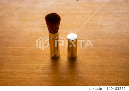 Retractable Makeup Brush and Silver Cap on Wooden Background with Copy Space 140483232