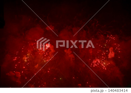 Stunning and colorful fireworks display in the night sky with smoke during explosion. Real fireworks background. Abstract of real shining fireworks against black background. for celebration. Stunning and colorful fireworks display in the night sky with smoke during explosion. Real fireworks background. Abstract of real shining fireworks against black background. for celebration. 140483414