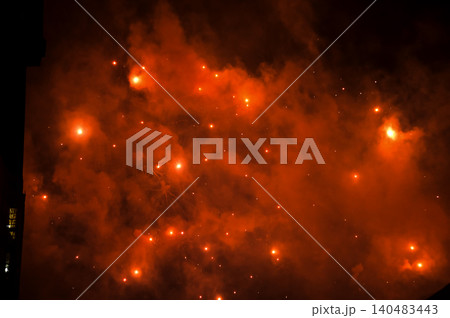 Stunning and colorful fireworks display in the night sky with smoke during explosion. Real fireworks background. Abstract of real shining fireworks against black background. for celebration. Stunning and colorful fireworks display in the night sky with smoke during explosion. Real fireworks background. Abstract of real shining fireworks against black background. for celebration. 140483443