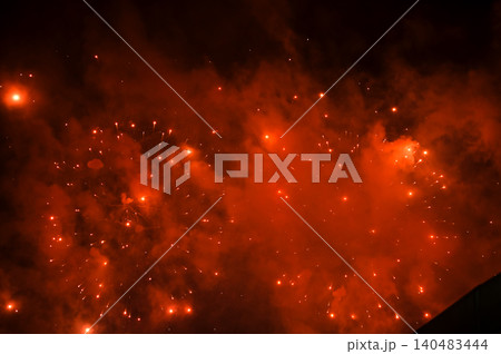 Stunning and colorful fireworks display in the night sky with smoke during explosion. Real fireworks background. Abstract of real shining fireworks against black background. for celebration. Stunning and colorful fireworks display in the night sky with smoke during explosion. Real fireworks background. Abstract of real shining fireworks against black background. for celebration. 140483444