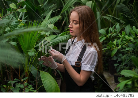 Female gardener work in botanical garden Female gardener work in botanical garden 140483792