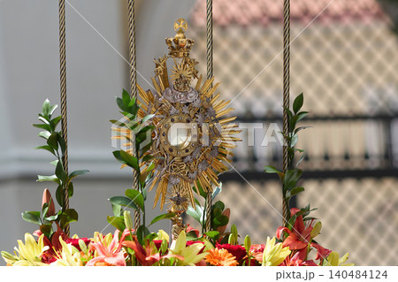 Gold monstrance displaying eucharist during religious procession Gold monstrance displaying eucharist during religious procession 140484124