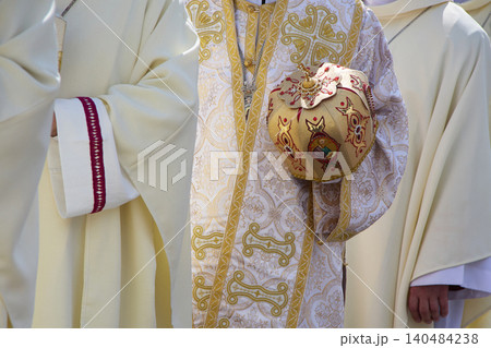 Orthodox priest holding miter during religious ceremony Orthodox priest holding miter during religious ceremony 140484238