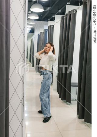 Fashion Shopper Adjusting Outfit In Modern Fitting Room 140484488