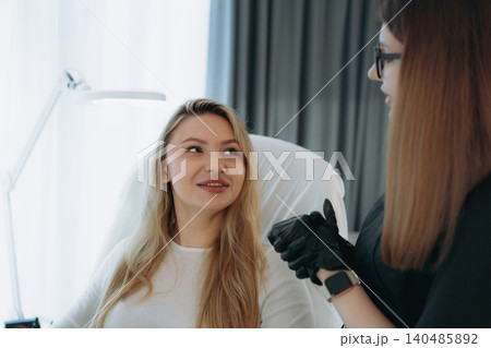 woman before facian rejuvenation injection at aesthetic clinic . Doctor explains procedure woman before facian rejuvenation injection at aesthetic clinic . Doctor explains procedure 140485892