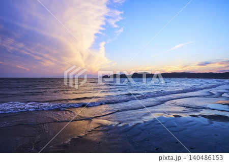 Dramatic Sunset Clouds Dividing Blue Sky Over Ocea 140486153