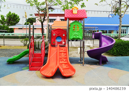 Climbing structures and slides are playground equipment for children, which are part of the public park. Climbing structures and slides are playground equipment for children, which are part of the public park. 140486239