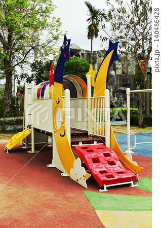 A large outdoor playground for children with a variety of play equipment, which is part of the public park. A large outdoor playground for children with a variety of play equipment, which is part of the public park. 140486428
