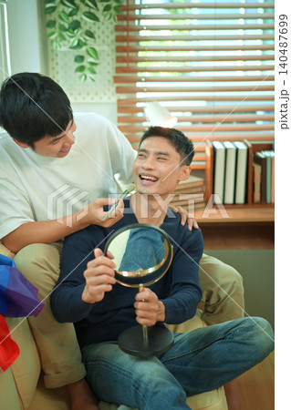 LGBTQ partners sharing beauty routine together LGBTQ partners sharing beauty routine together 140487699