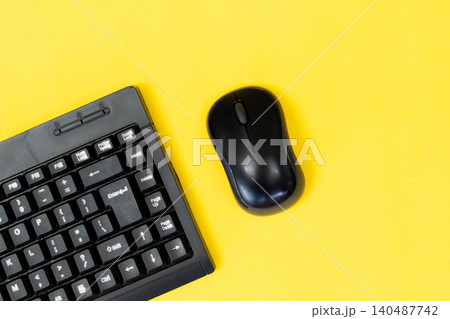 Yellow background with sleek black keyboard and mouse. Minimalist tech setup for digital creators or students. Modern design evokes focus, calm, and productivity. Perfect for blogs, ads Yellow background with sleek black keyboard and mouse. Minimalist tech setup for digital creators or students. Modern design evokes focus, calm, and productivity. Perfect for blogs, ads 140487742