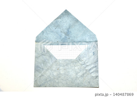 Textured paper envelope, made in vintage style with a sheet of paper from a notebook inside. 140487869
