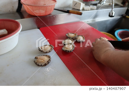 Prepping Abalone in a Kitchen Setting Prepping Abalone in a Kitchen Setting 140487907