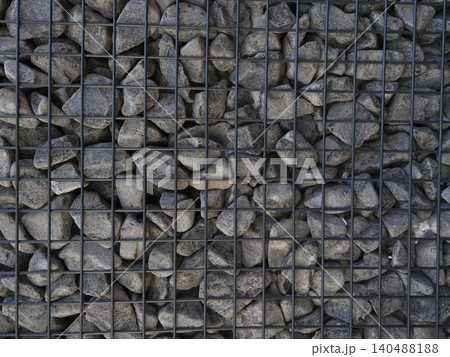 a wall of stones inside the iron barrier a wall of stones inside the iron barrier 140488188