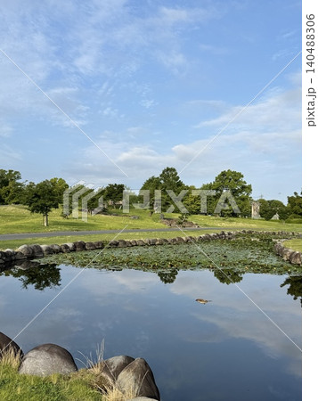 朝の静かな池に青空と新緑が映り込む城沼の公園 140488306