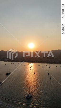 Sunset coastal city. Boats coastal town. Coastal mountain landscape, sea resort yachts, golden hour Sunset coastal city. Boats coastal town. Coastal mountain landscape, sea resort yachts, golden hour 140490181