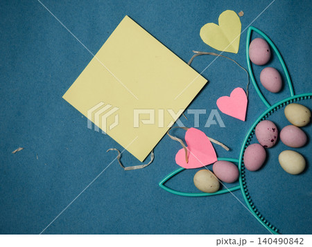 Easter display with bunny rabbit ears and eggs blue background Easter display with bunny rabbit ears and eggs blue background 140490842