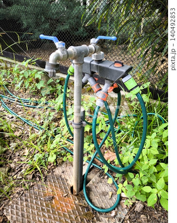 Garden water tap with a splitter and hoses Garden water tap with a splitter and hoses 140492853