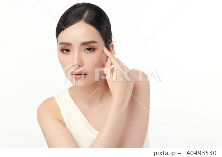 A beautiful young Asian woman with clean, fresh skin against a white background. Skincare, facial treatment, cosmetology, beauty, and spa. An elegant portrait of an Asian woman. 140493530