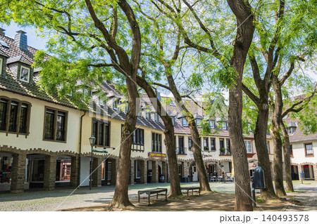 Germany old town square with traditional half timbered houses and green trees, historic european city street view in summer, charming architecture of ancient village plaza Germany old town square with traditional half timbered houses and green trees, historic european city street view in summer, charming architecture of ancient village plaza 140493578