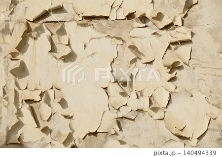 Texture or background of the Cracked and peeling paint on the wall. Close-up view. Grunge old texture. Abstract background. Vintage style. Scratched and chipped surface. Texture or background of the Cracked and peeling paint on the wall. Close-up view. Grunge old texture. Abstract background. Vintage style. Scratched and chipped surface. 140494339