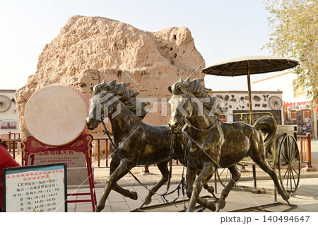 The ancient metal horses and carriage statues in the ancient city of Kuche on the Silk Road and the enchanting city of Aksu. Kuche, a colorful ancient kingdom. The ancient metal horses and carriage statues in the ancient city of Kuche on the Silk Road and the enchanting city of Aksu. Kuche, a colorful ancient kingdom. 140494647