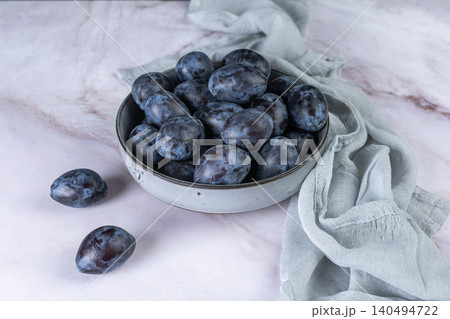 Fresh plums in a clay bowl. 140494722