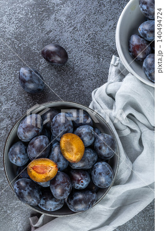 Fresh plums in a clay bowl. Fresh plums in a clay bowl. 140494724