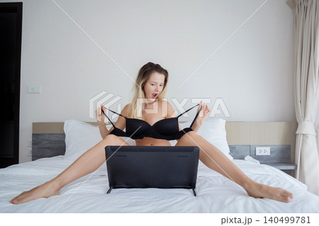Young sexy woman posing in front of camera and working as webcam model 140499781