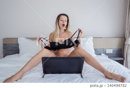 Young sexy woman posing in front of camera and working as webcam model 140499782