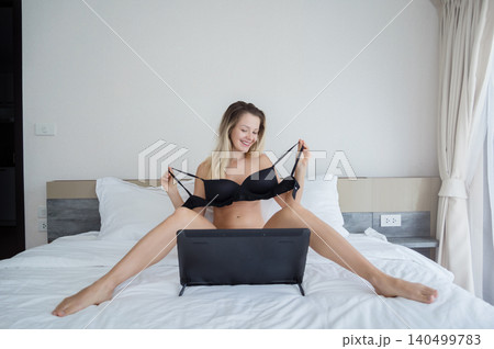 Young sexy woman posing in front of camera and working as webcam model 140499783