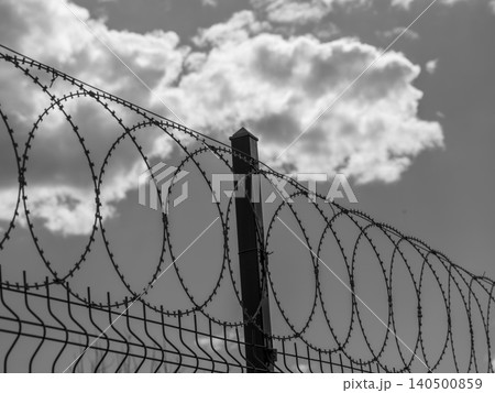 barbed wire on prison wall 140500859