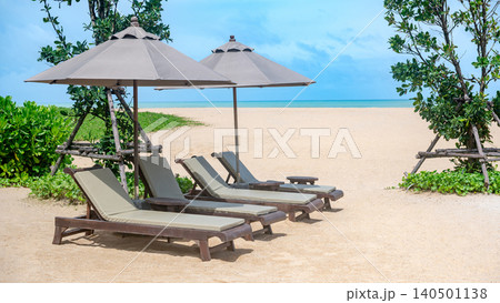 Beach chairs or loungers under the umbrellas on tropical beach Beach chairs or loungers under the umbrellas on tropical beach 140501138