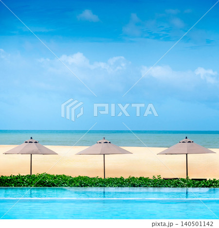 Luxury swimming pool with beach umbrella and sea landscape ahead Luxury swimming pool with beach umbrella and sea landscape ahead 140501142