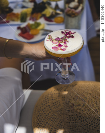 a woman drinking a refreshing cocktail in summer a woman drinking a refreshing cocktail in summer 140501440