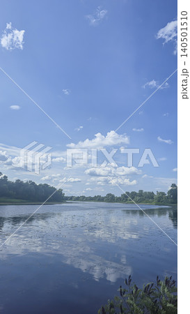 A deep river surrounded by trees and plants Thickets of reeds. Voluminous clouds A deep river surrounded by trees and plants Thickets of reeds. Voluminous clouds 140501510