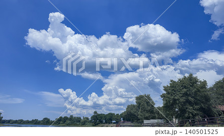 A deep river surrounded by trees and plants Thickets of reeds. Voluminous clouds A deep river surrounded by trees and plants Thickets of reeds. Voluminous clouds 140501525