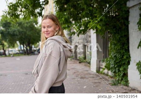 Young woman smiling in urban park alley Young woman smiling in urban park alley 140501954