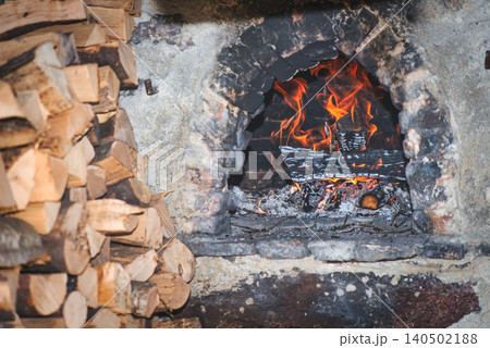 Traditional Wood-Fired Brick Oven with Burning Firewood 140502188