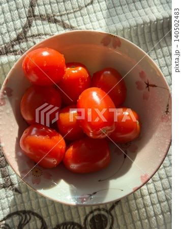 Fresh and juicy cherry tomatoes with vibrant red color and sweet, tangy flavor. Perfect for salads, snacking, or adding a burst of freshness to any dish. 140502483