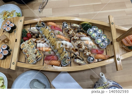 An assortment of fresh sushi, artfully arranged with a variety of toppings and vibrant colors. This traditional Japanese dish combines vinegared rice, seafood, and vegetables for an experience. An assortment of fresh sushi, artfully arranged with a variety of toppings and vibrant colors. This traditional Japanese dish combines vinegared rice, seafood, and vegetables for an experience. 140502593