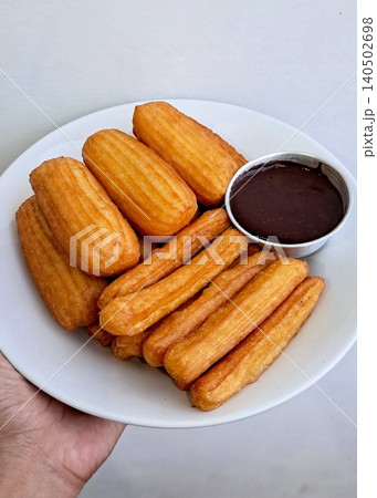 Churros, crispy and golden, dusted with sugar and cinnamon. A delicious, sweet treat often enjoyed with chocolate dipping sauce, perfect for satisfying any dessert craving. Churros, crispy and golden, dusted with sugar and cinnamon. A delicious, sweet treat often enjoyed with chocolate dipping sauce, perfect for satisfying any dessert craving. 140502698