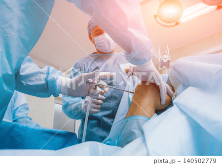 Arthroscope surgery. Orthopedic surgeons in teamwork in the operating room with modern arthroscopic tools. Knee surgery. 140502779
