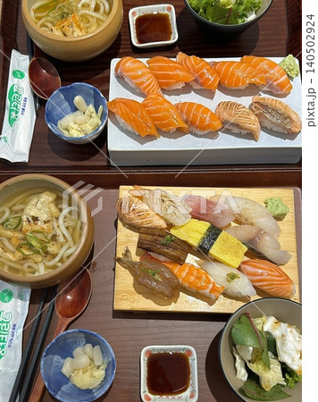 An assortment of fresh sushi, artfully arranged with a variety of toppings and vibrant colors. This traditional Japanese dish combines vinegared rice, seafood, and vegetables for an experience. An assortment of fresh sushi, artfully arranged with a variety of toppings and vibrant colors. This traditional Japanese dish combines vinegared rice, seafood, and vegetables for an experience. 140502924
