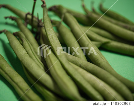 Raw green beans green background Raw green beans green background 140502968