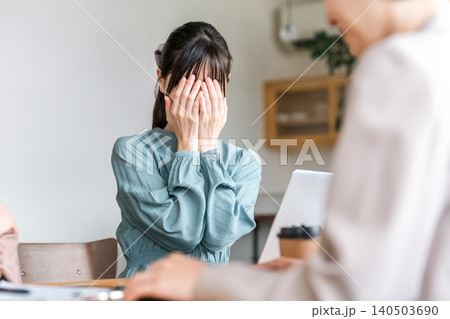 ミーティング中に泣いてしまう若いビジネスウーマン ミーティング中に泣いてしまう若いビジネスウーマン 140503690