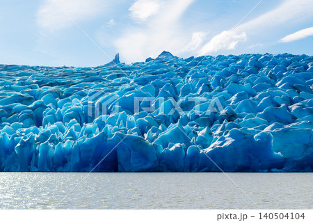 Patagonia glacier ice wall over water under bright sky Patagonia glacier ice wall over water under bright sky 140504104