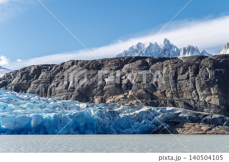 Patagonia glacier, icy lake, rocky cliff, blue sky, mountain peak, calm water Patagonia glacier, icy lake, rocky cliff, blue sky, mountain peak, calm water 140504105