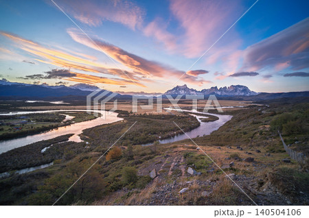 Patagonia river valley sunset landscape with mountain range and colorful sky Patagonia river valley sunset landscape with mountain range and colorful sky 140504106
