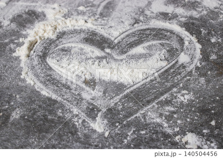 A Heart Shaped Impression in Flour on a Rustic Surface, Symbolizing Love and Culinary Creativity 140504456